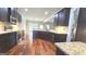 Kitchen featuring granite countertops, stainless steel appliances, and hardwood flooring at 207 Birchwood Dr, Loganville, GA 30052
