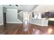 Open living area connecting kitchen and staircase with hardwood flooring throughout at 207 Birchwood Dr, Loganville, GA 30052