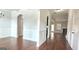 Open-concept living area featuring hardwood floors, wainscoting, and an arched doorway at 207 Birchwood Dr, Loganville, GA 30052