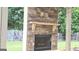 An attractive outdoor stone fireplace provides an area for outdoor relaxation and entertainment at 207 Birchwood Dr, Loganville, GA 30052