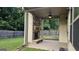 Covered patio featuring a stone fireplace, ceiling fan, and ample space for outdoor enjoyment at 207 Birchwood Dr, Loganville, GA 30052