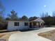 Charming single-story home featuring a welcoming front porch and a well-maintained lawn at 3335 Highway 20 Ne, Conyers, GA 30012