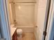 Bathroom featuring shower-tub combo with white tile and a white door at 3874 Austin Park Ne Ln, Decatur, GA 30032