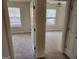 Bedroom with wall-to-wall carpeting and a large window, viewed through a doorway at 3874 Austin Park Ne Ln, Decatur, GA 30032