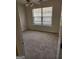 Bedroom with wall-to-wall carpeting and a large bright window, viewed through a doorway at 3874 Austin Park Ne Ln, Decatur, GA 30032