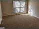 Bright bedroom with a large window and neutral carpet flooring at 3874 Austin Park Ne Ln, Decatur, GA 30032