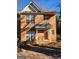 Traditional brick townhouse with a covered front porch and well-maintained landscaping at 3874 Austin Park Ne Ln, Decatur, GA 30032