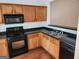Kitchen features light wood cabinets, black countertops, stainless steel sink and appliances at 3874 Austin Park Ne Ln, Decatur, GA 30032