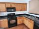 Cozy kitchen features light wood cabinets, black countertops, stainless steel sink and appliances at 3874 Austin Park Ne Ln, Decatur, GA 30032