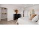 Bright bedroom features wood floors, neutral walls, a walk-in closet, and a decorative dresser with mirror at 745 Myrica Ave, Locust Grove, GA 30248