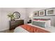 Well-lit bedroom with decorative pillows and bedding, and a dark wood dresser at 745 Myrica Ave, Locust Grove, GA 30248