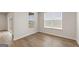Spacious bedroom with wood-look floors, light walls, and natural light from the windows at 275 Arwen Dr # 68, Mcdonough, GA 30252