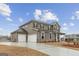 Spacious home featuring a three-car garage, gray siding and a long driveway at 275 Arwen Dr # 68, Mcdonough, GA 30252