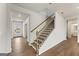 Bright foyer with wood floors, staircase with wood handrail and black balusters at 275 Arwen Dr # 68, Mcdonough, GA 30252