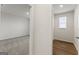 Hallway with view to bedroom featuring wood-look floors and view to carpeted room at 275 Arwen Dr # 68, Mcdonough, GA 30252