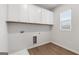 Neat laundry room featuring wooden floors, utility connections and white cabinetry at 275 Arwen Dr # 68, Mcdonough, GA 30252
