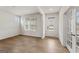 Bright living room featuring wood floors, white walls, windows, and glass-paneled doors at 275 Arwen Dr # 68, Mcdonough, GA 30252