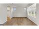 An open room featuring wood floors, white walls, and large windows at 275 Arwen Dr # 68, Mcdonough, GA 30252