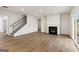 Bright living room featuring wood-look floors, fireplace, and access to outdoors at 275 Arwen Dr # 68, Mcdonough, GA 30252