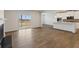 Bright living room featuring wood-look floors, fireplace, and view of a kitchen at 275 Arwen Dr # 68, Mcdonough, GA 30252