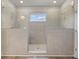Modern tiled shower with glass doors and dual showerheads, offering a spa-like experience at 275 Arwen Dr # 68, Mcdonough, GA 30252