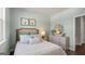 Comfortable bedroom with neutral colors and natural light, includes a double bed and decorative artwork at 741 Myrica Ave, Locust Grove, GA 30248