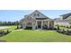 Beautiful home with a manicured lawn, covered entryway, and stone accents, set in a serene location at 741 Myrica Ave, Locust Grove, GA 30248