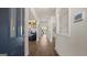 View of a long, well-lit hallway with hardwood floors leading through the home's main living areas at 741 Myrica Ave, Locust Grove, GA 30248
