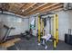 Basement gym features modern workout equipment, concrete walls and exposed utilities at 1408 Hemphill Rd, Stockbridge, GA 30281
