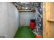 Unfinished basement area features playful green turf and a vintage utility closet at 1408 Hemphill Rd, Stockbridge, GA 30281