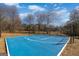 Full basketball court with blue surface and surrounding trees at 1408 Hemphill Rd, Stockbridge, GA 30281