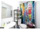 Bathroom features a graffiti shower curtain, modern fixtures, and vanity at 1408 Hemphill Rd, Stockbridge, GA 30281