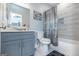 Modern bathroom with a unique glass vessel sink, grey vanity, and silver fixtures at 1408 Hemphill Rd, Stockbridge, GA 30281