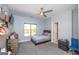 Cozy bedroom with a ceiling fan, neutral-toned walls, and carpet, offering a comfortable and inviting space at 1408 Hemphill Rd, Stockbridge, GA 30281