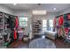 Spacious walk-in closet with ample storage, a unique chandelier, and a convenient window at 1408 Hemphill Rd, Stockbridge, GA 30281