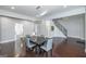 Open dining area featuring a contemporary chandelier, dark wood floors, and gray walls at 1408 Hemphill Rd, Stockbridge, GA 30281