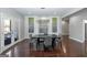 Elegant dining room with a modern chandelier, artwork, and French doors to the outdoor patio at 1408 Hemphill Rd, Stockbridge, GA 30281