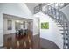 Dining area featuring a modern chandelier and sleek table, set off of the light-filled foyer at 1408 Hemphill Rd, Stockbridge, GA 30281