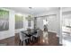 Bright dining space featuring a modern chandelier, gray walls, artwork, and dark hardwood floors at 1408 Hemphill Rd, Stockbridge, GA 30281