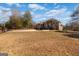 View of the brick home from the large front yard. Circular driveway with fountain and wrought iron gate at 1408 Hemphill Rd, Stockbridge, GA 30281