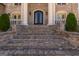 Elegant brick home featuring an impressive entrance with stately columns and intricate double doors at 1408 Hemphill Rd, Stockbridge, GA 30281
