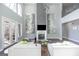 Bright living room features tall windows and a contemporary fireplace and stylish decor at 1408 Hemphill Rd, Stockbridge, GA 30281