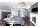Inviting main bedroom boasting hardwood floors, a tray ceiling, and a cozy fireplace at 1408 Hemphill Rd, Stockbridge, GA 30281