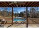 Covered patio with ceiling fan, outdoor seating, and view of the pool and basketball court at 1408 Hemphill Rd, Stockbridge, GA 30281