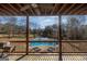 Covered patio with ceiling fan, outdoor seating, and view of the pool and basketball court at 1408 Hemphill Rd, Stockbridge, GA 30281