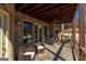 Covered patio with brick exterior, ceiling fan, and outdoor seating at 1408 Hemphill Rd, Stockbridge, GA 30281