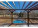 View of the pool and basketball court from the covered deck overlooking the backyard at 1408 Hemphill Rd, Stockbridge, GA 30281
