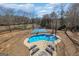 Aerial view of the pool and basketball court surrounded by trees at 1408 Hemphill Rd, Stockbridge, GA 30281