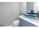 Stylish powder room features a vessel sink and a gray vanity at 1408 Hemphill Rd, Stockbridge, GA 30281