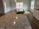 A modern kitchen island features a stainless steel sink, granite countertops, and white cabinets at 5311 Tuscany Dr # 98 Plapprox Sqft, Douglasville, GA 30135